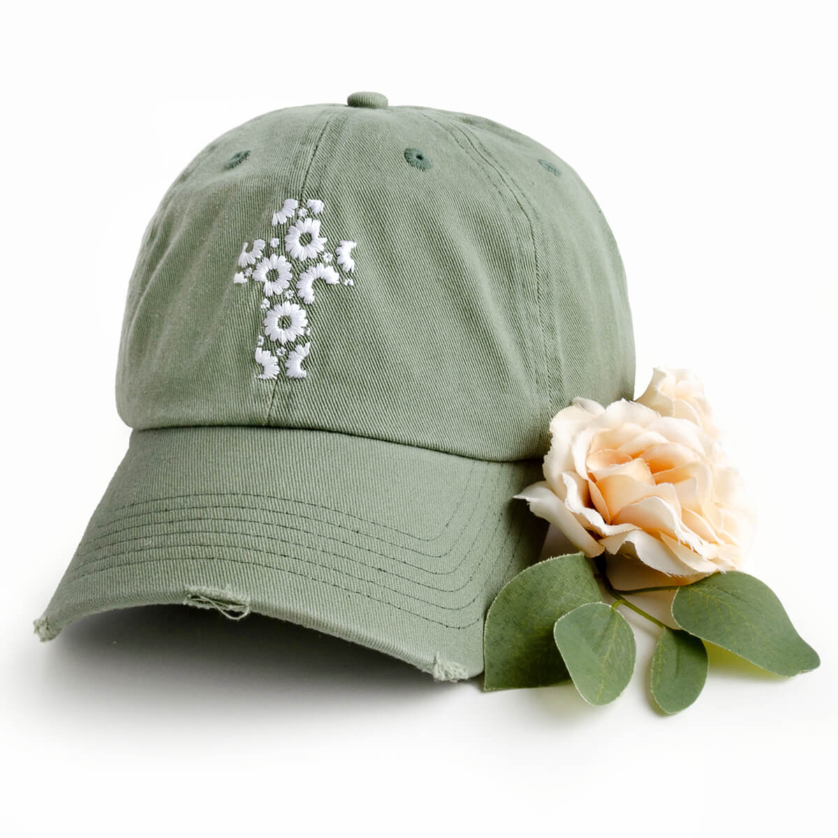 Green Christian hat featuring an embroidered floral cross