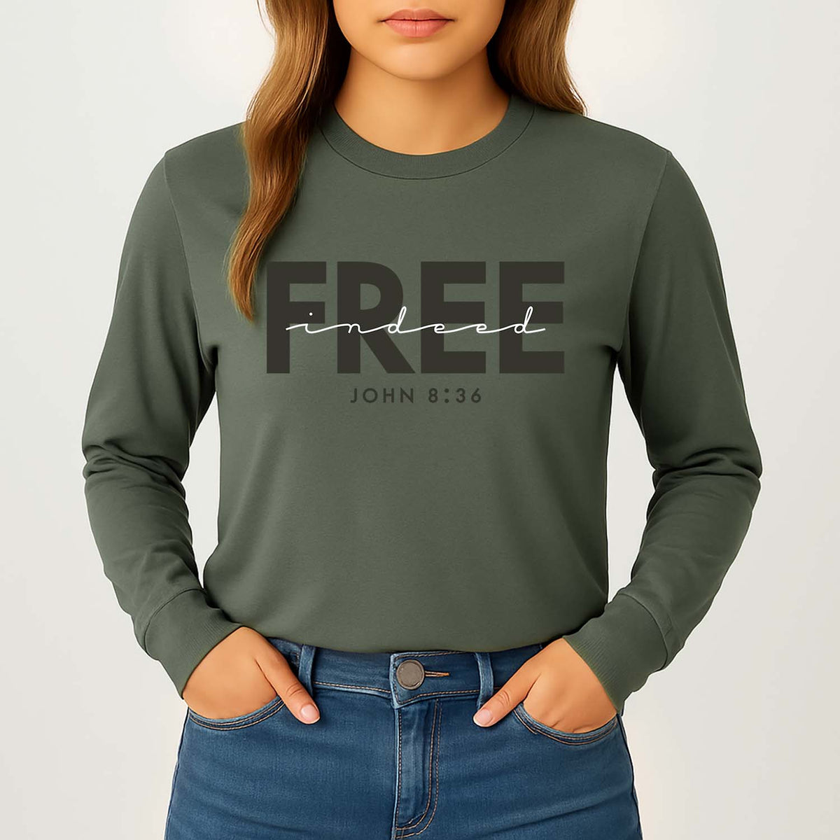 Woman wearing a green long-sleeve shirt with 'FREE indeed JOHN 8:36' inscription in black and white