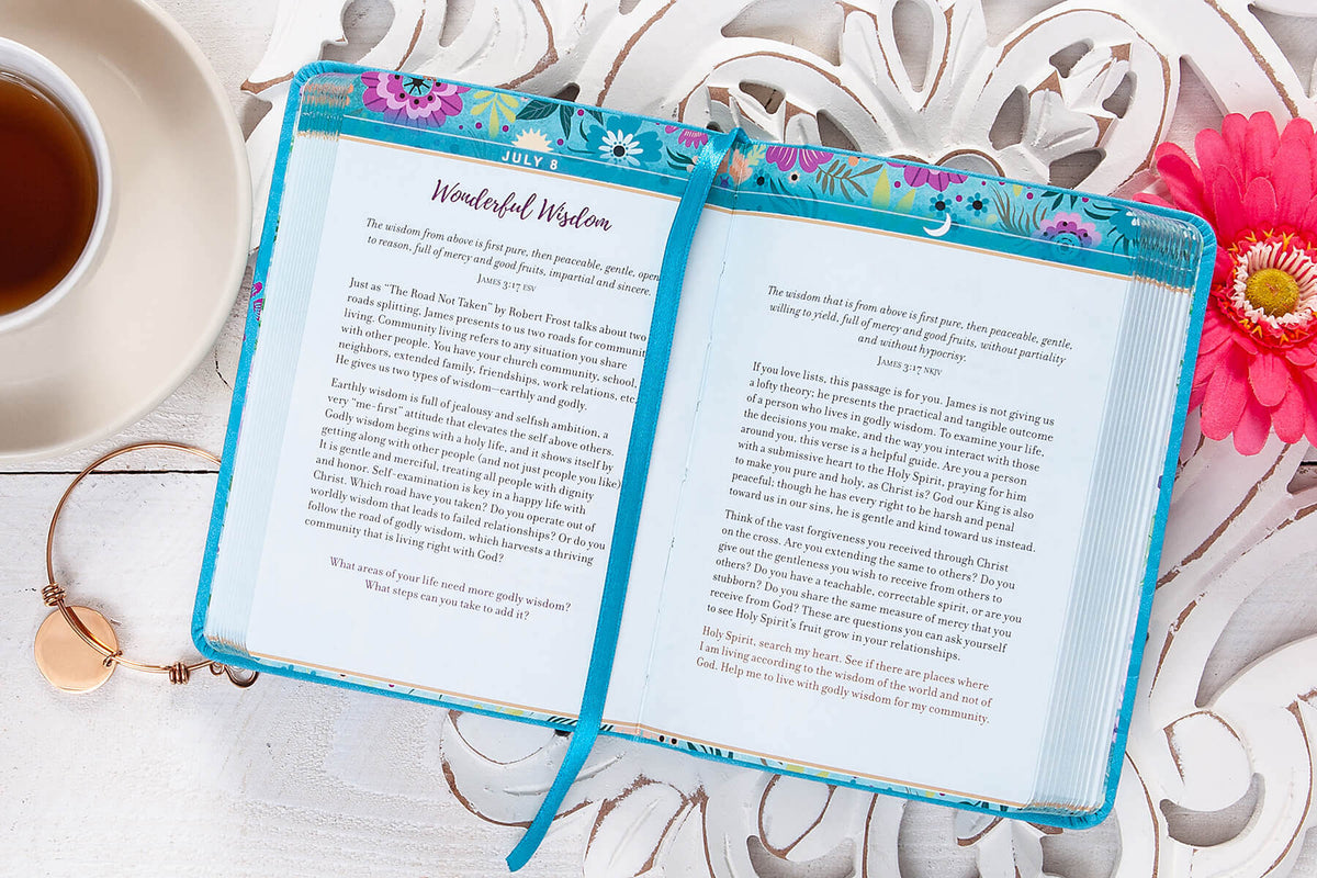 Floral notebook with a tea cup and decorative elements on a white surface