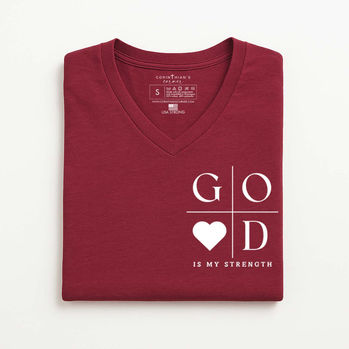 Folded maroon t-shirt with 'GOD IS MY STRENGTH' text and heart design on a white background
