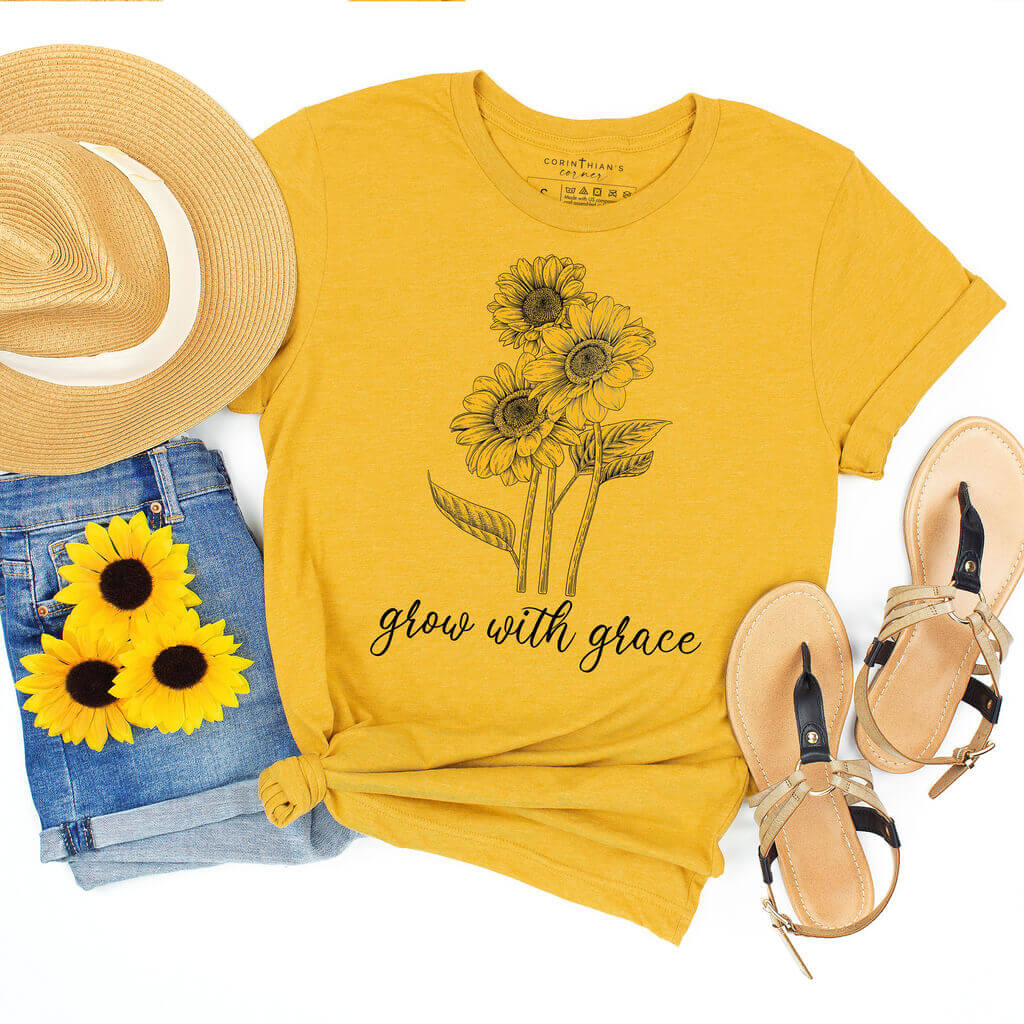 Adorable sunflower graphic on a yellow t-shirt alongside "grow with grace" text