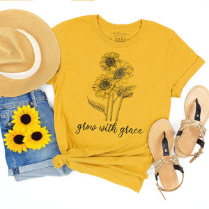 Adorable sunflower graphic on a yellow t-shirt alongside "grow with grace" text