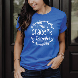Happy young woman wearing the royal blue His grace is enough top