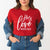 Our bright red Valentine's day shirt proudly declares "His love never fails"