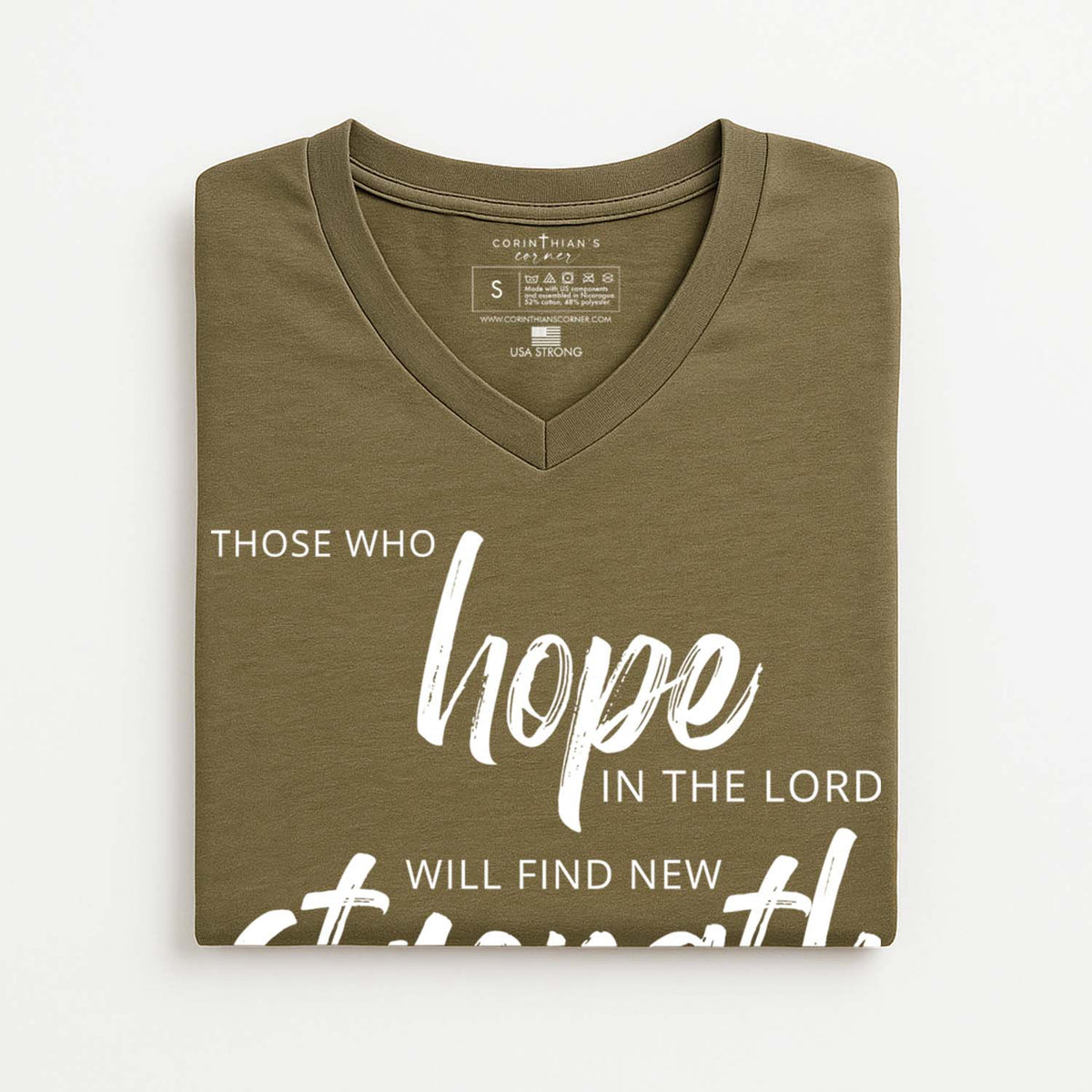 Folded olive green t-shirt with Christian quote on a white background
