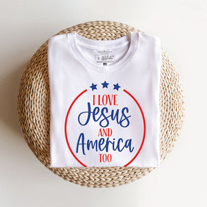 Folded white t-shirt that reads I love Jesus and America too