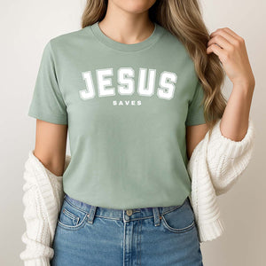 Woman wearing a green t-shirt with 'JESUS SAVES' text on a plain background