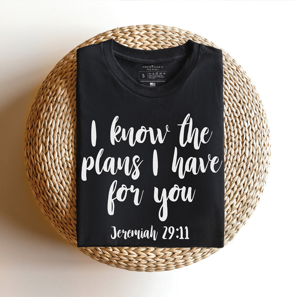 Folded black t-shirt reading I know the plans I have for you Jeremiah 29:11