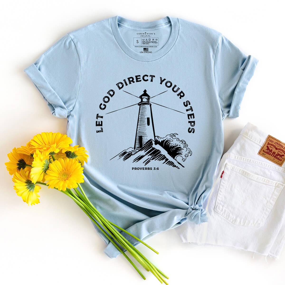 Let God direct your steps light blue Christian t-shirt styled with flowers and white shorts