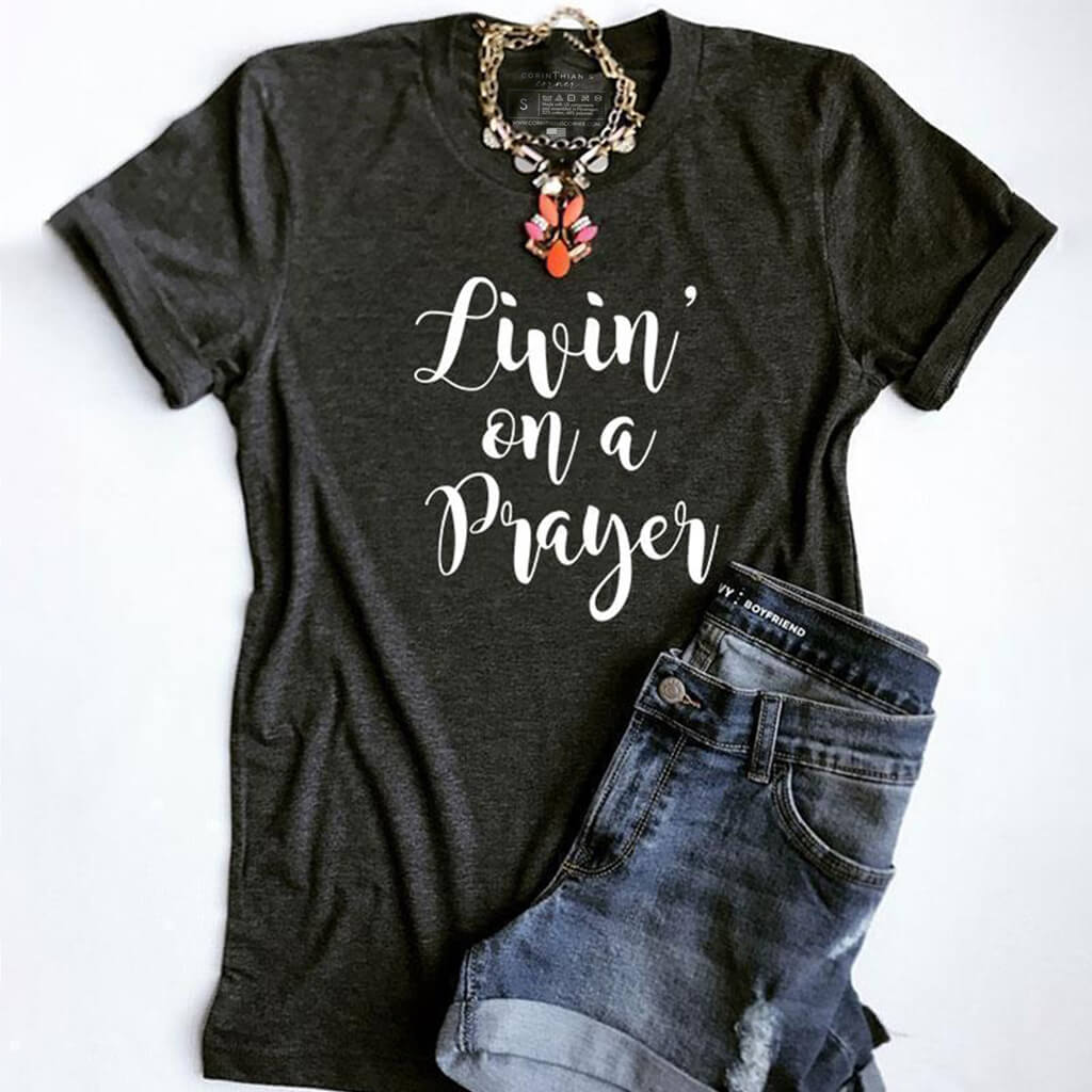 "Livin' on a prayer" printed on a premium gray women's Christian t-shirt