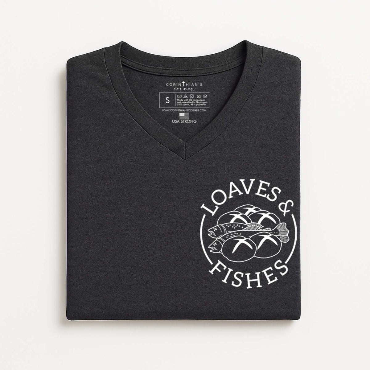 Folded black t-shirt with 'Loaves & Fishes' logo on a white background