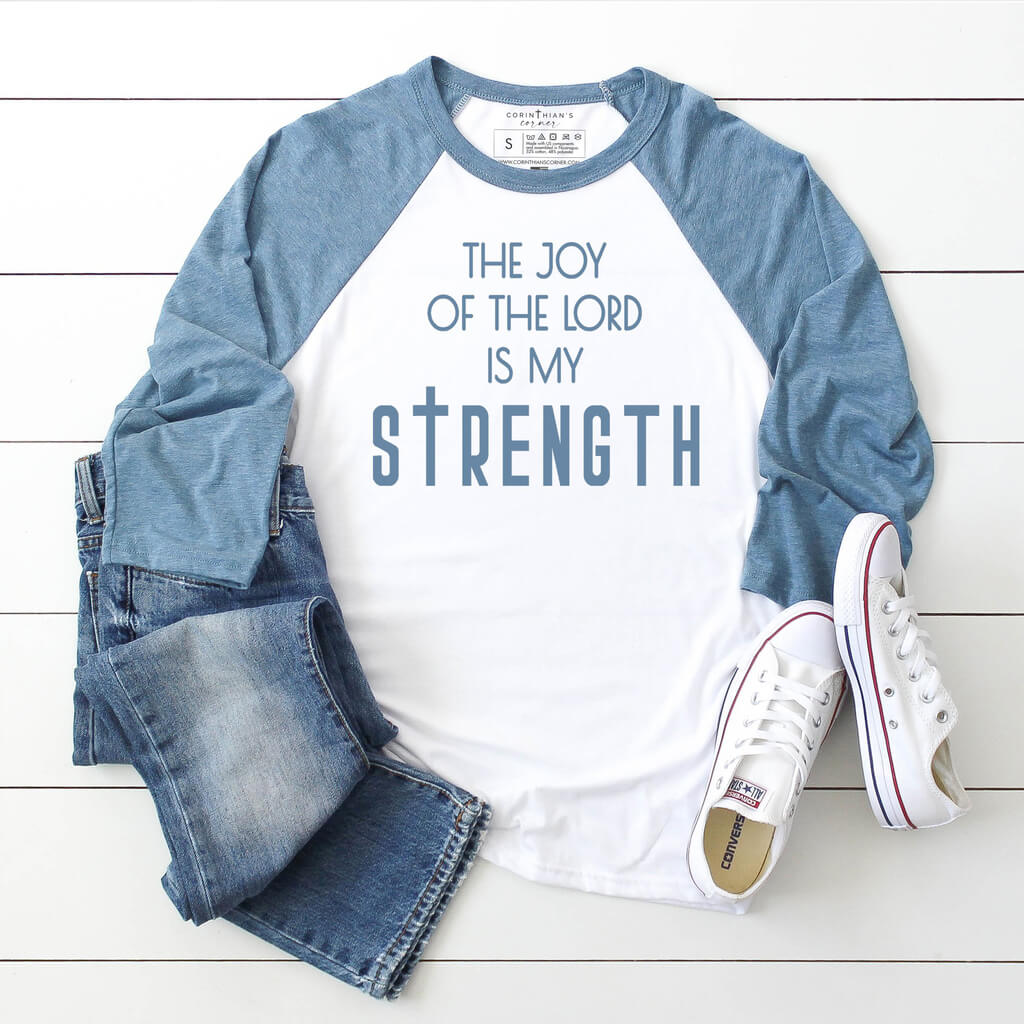 The joy of the Lord is my strength design printed on our premium blue and white raglan baseball tee