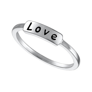Silver ring with the word 'love' etched on the surface