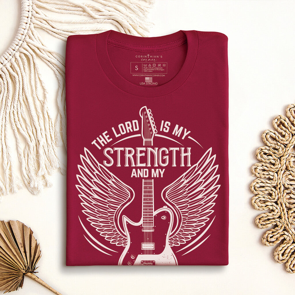 My strength and my song graphic Christian t-shirt hanging up with jeans