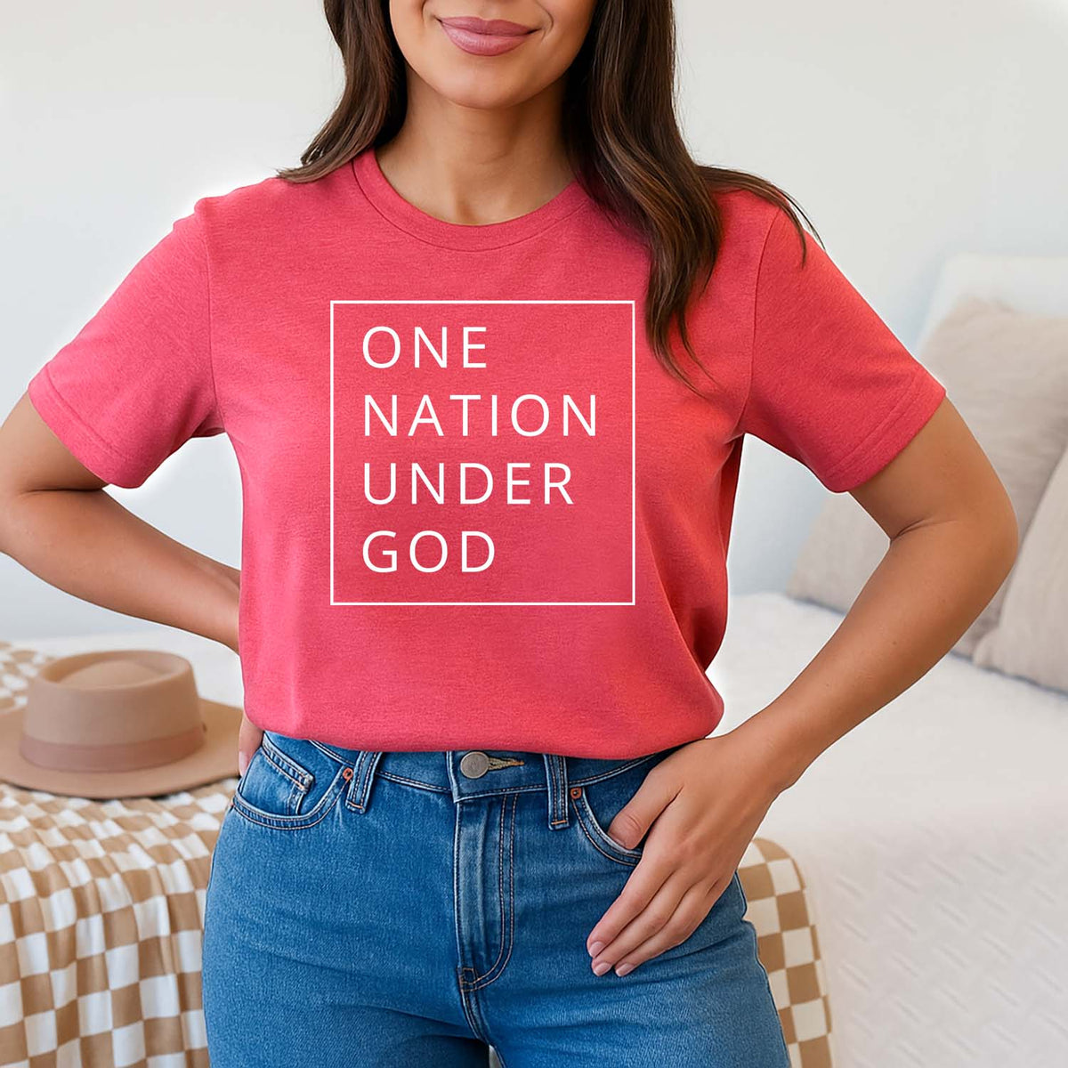 Woman wearing a red t-shirt with 'ONE NATION UNDER GOD' text.