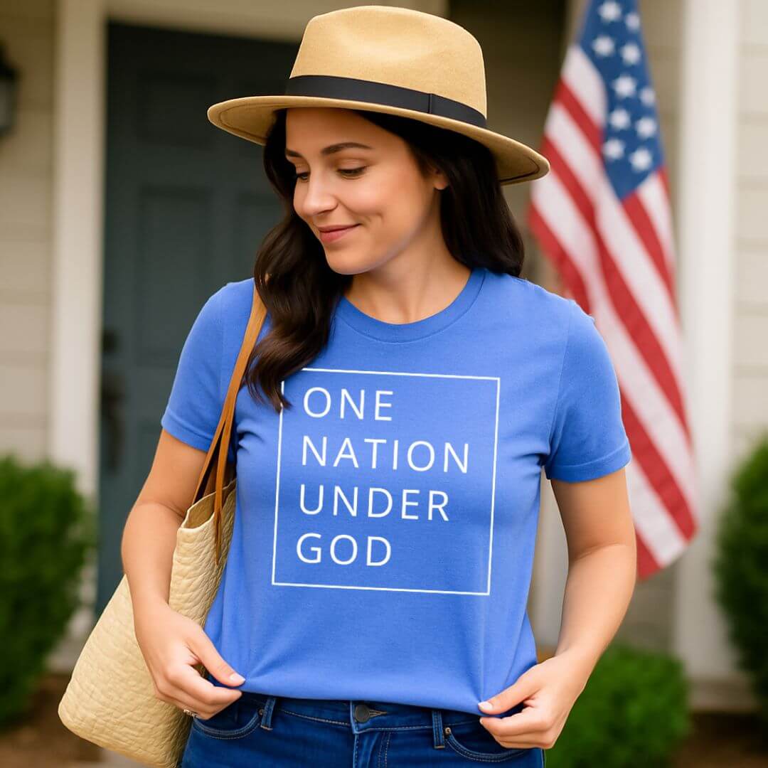 Young woman wearing a blue One Nation Under God Shirt in front of her home