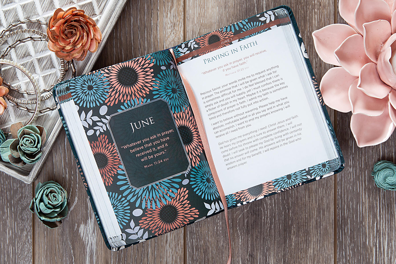 Decorative notebook with floral patterns and text on a wooden surface