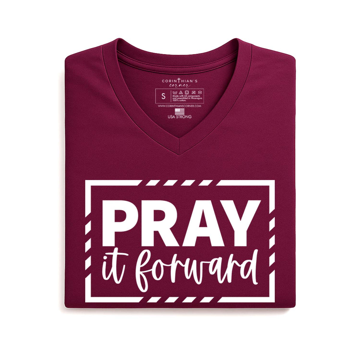Folded maroon t-shirt with 'PRAY it forward' text on a white background