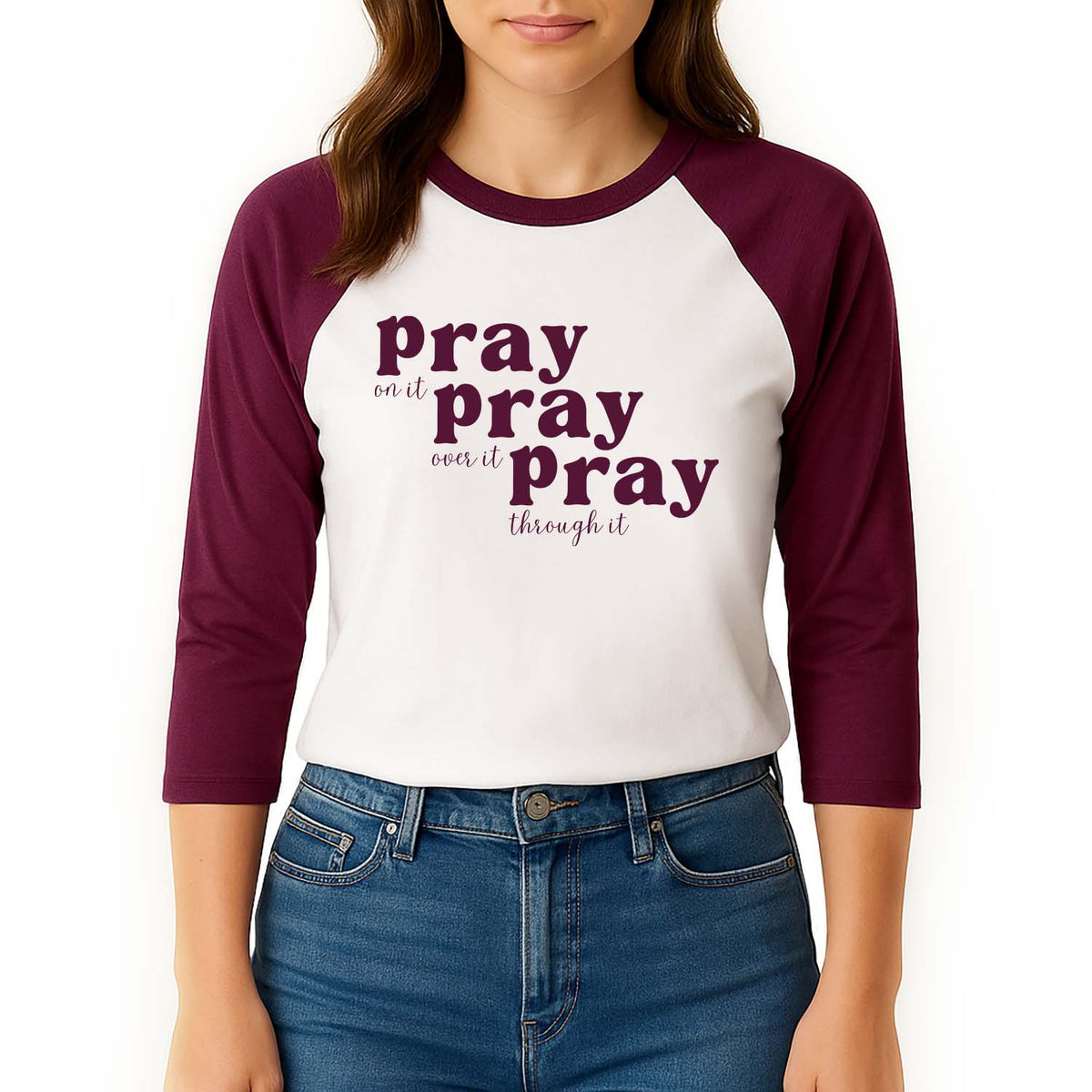 Woman modeling a maroon and white 3/4 sleeve shirt with 'Pray on it, pray over it, pray through it' text