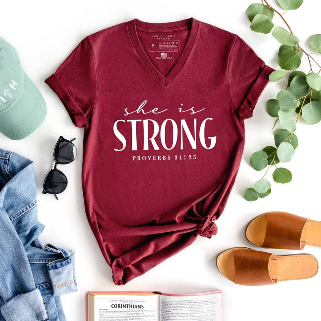 Inspiring red shirt that reads she is strong from proverbs 31:25