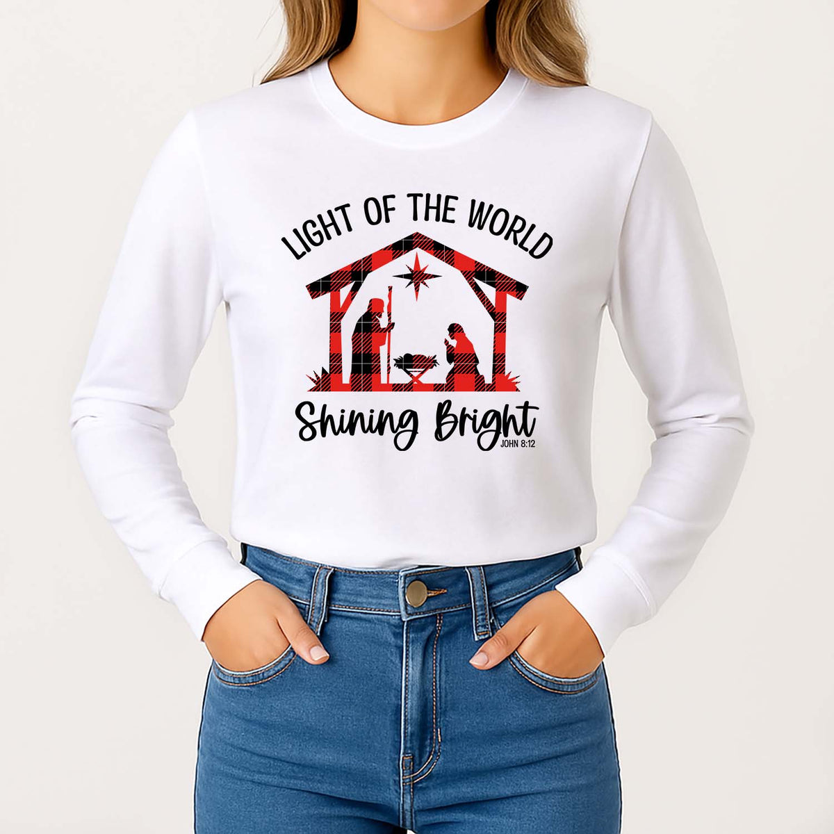White long-sleeve shirt with Christmas nativity design and text on a plain background