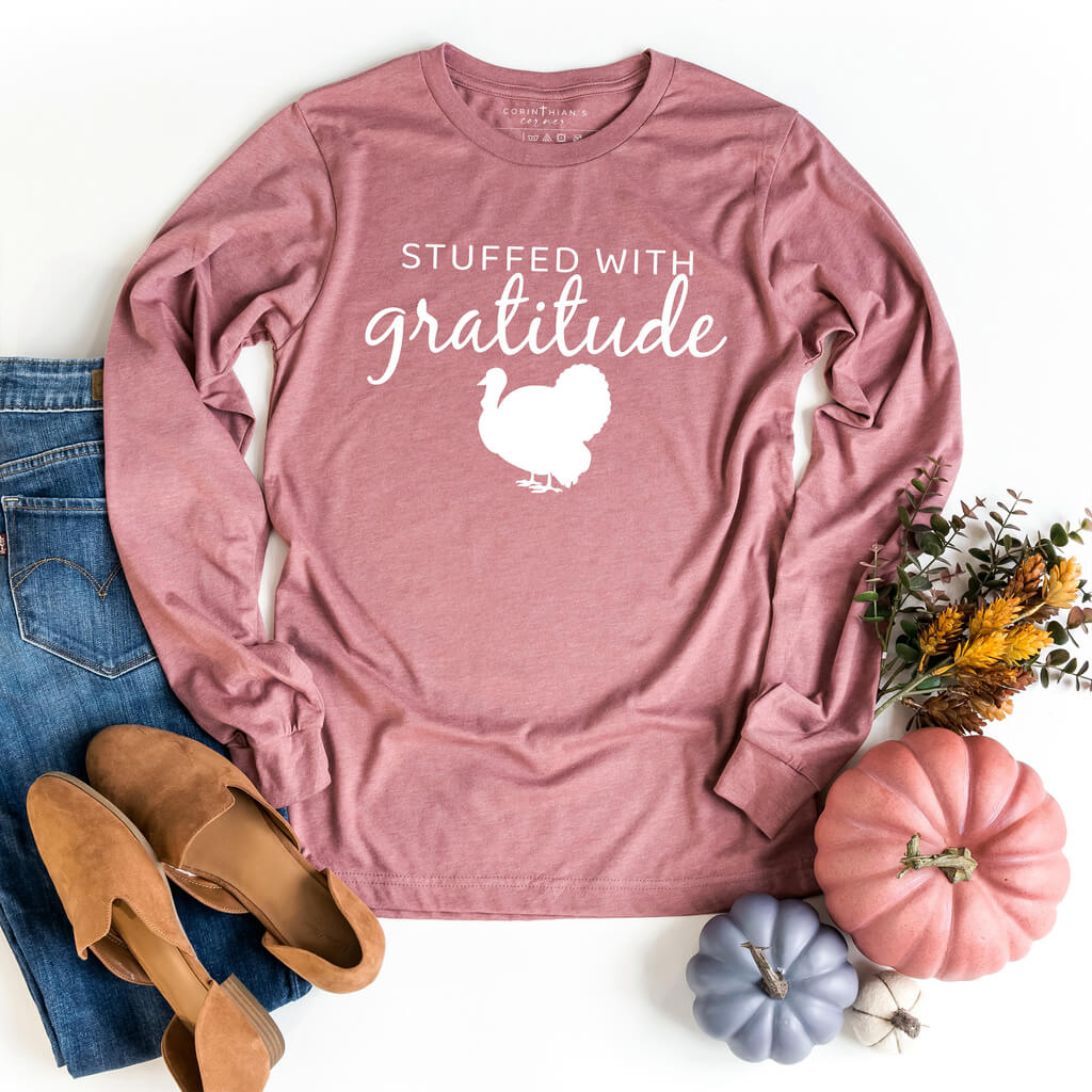 Thanksgiving long sleeve shirt in mauve that reads "stuffed with gratitude"