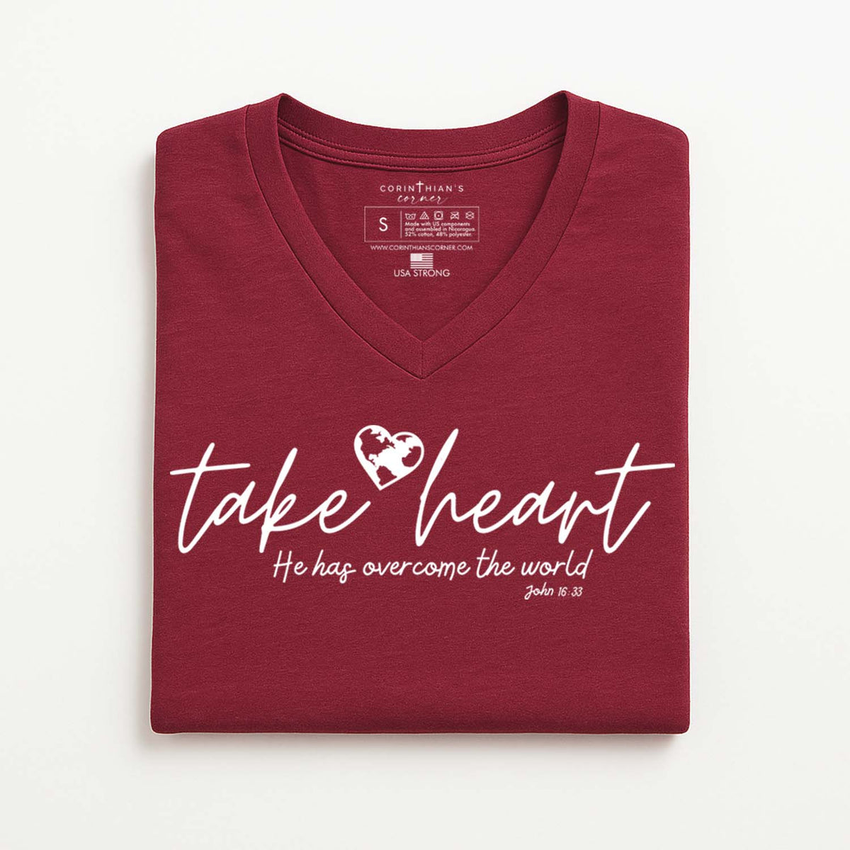 Folded maroon t-shirt with 'take heart' text and heart graphic on a white background