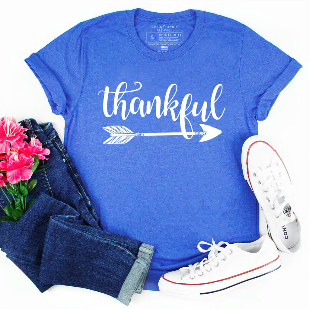 Vibrant blue t-shirt that says thankful with a decorative arrow