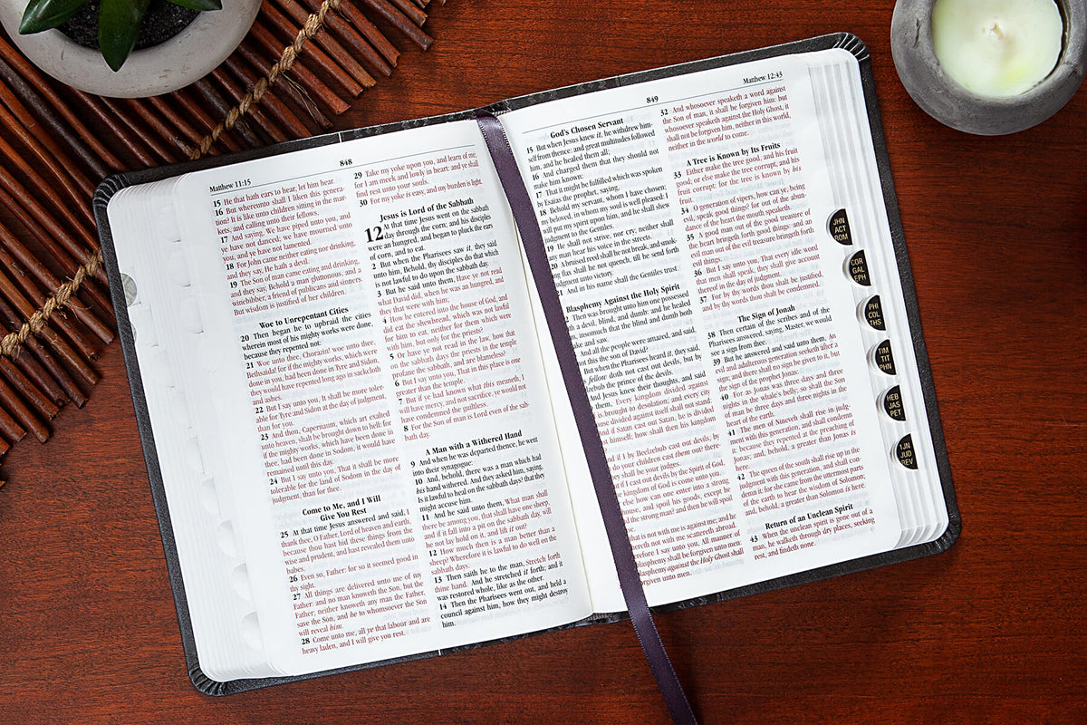 Open Bible with a bookmark on a wooden surface