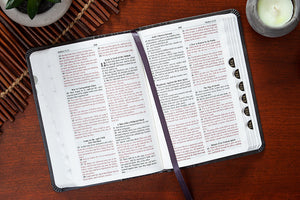 Open Bible with a bookmark on a wooden surface