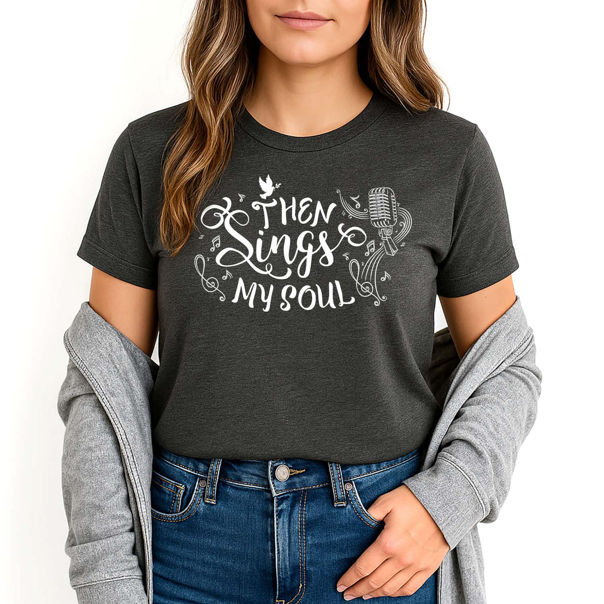 Woman wearing a dark gray t-shirt with 'Then Sings My Soul' text and graphics.