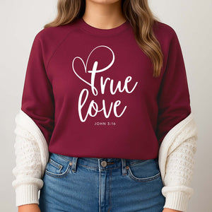 Maroon sweatshirt with 'True Love' Biblical text worn by a woman in jeans