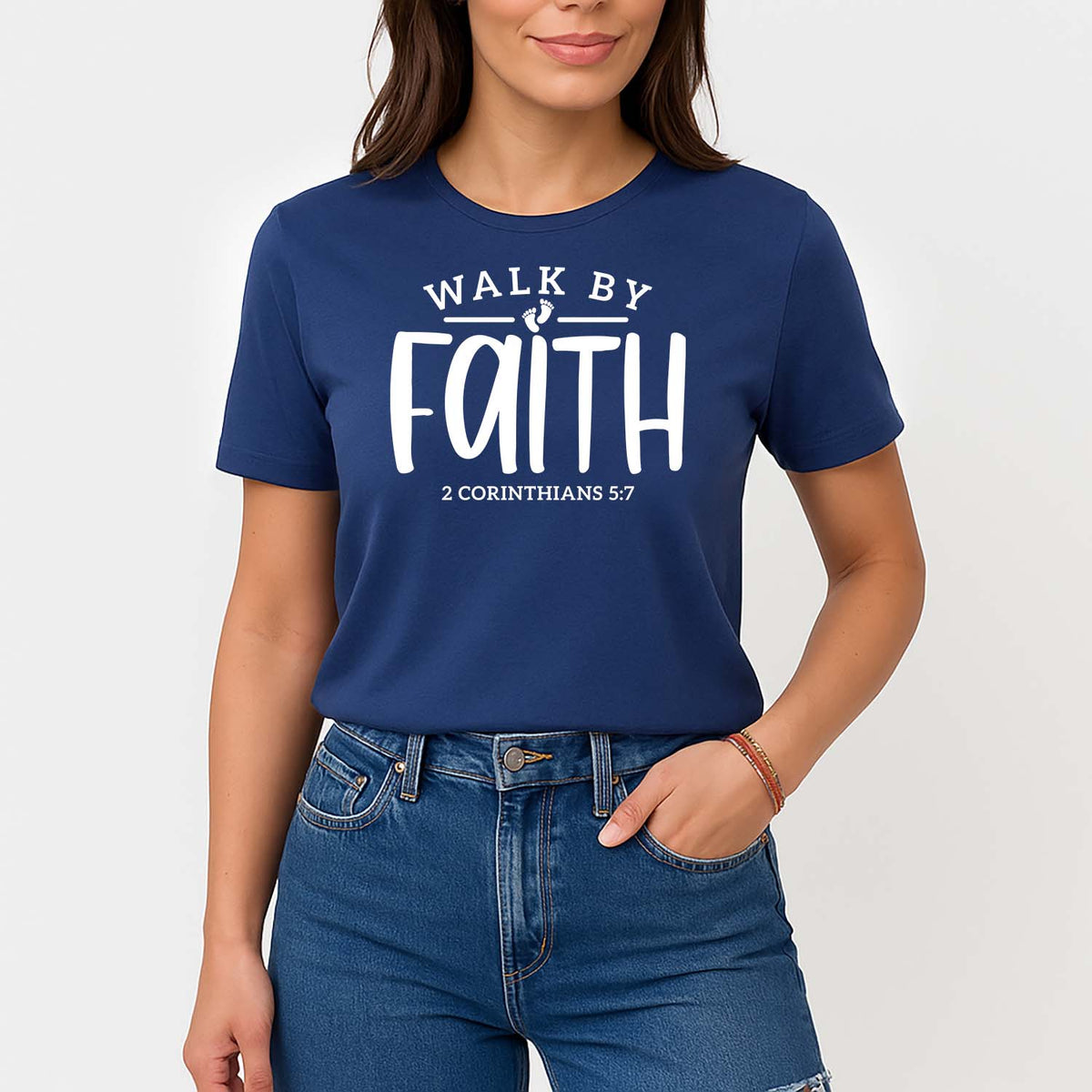 Woman wearing a blue t-shirt with 'Walk by Faith' text on a plain background