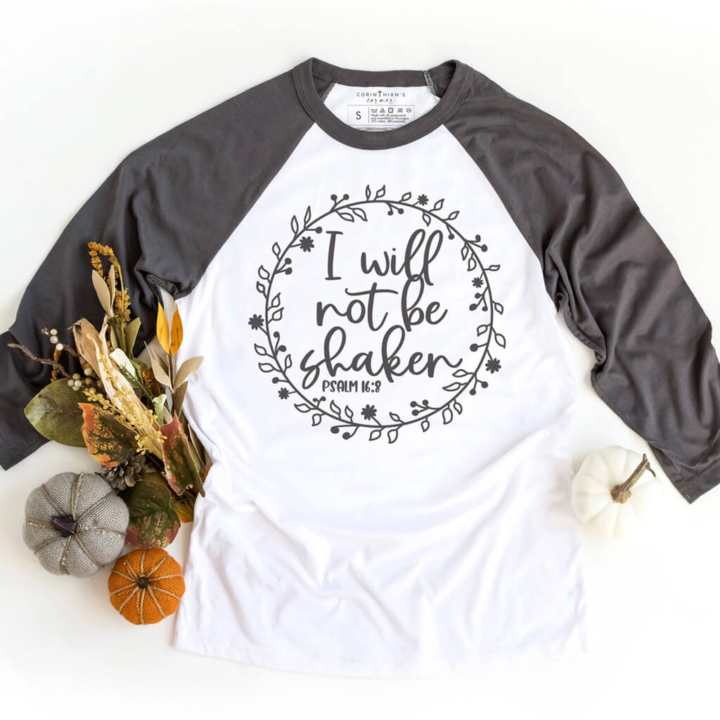 Verse from Psalm 16:8 printed on a charcoal and white 3/4 sleeve raglan shirt for women