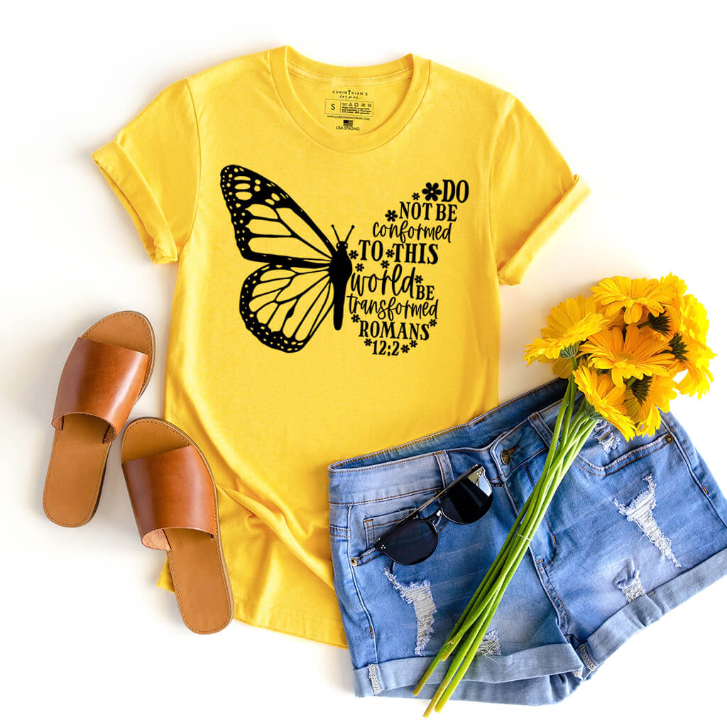 Yellow shirt with Bible passage from Romans 12:2 that reads be transformed