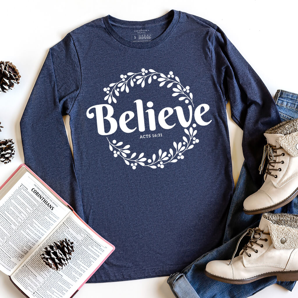Navy blue long sleeve inspired by Acts 16:31 that reads believe