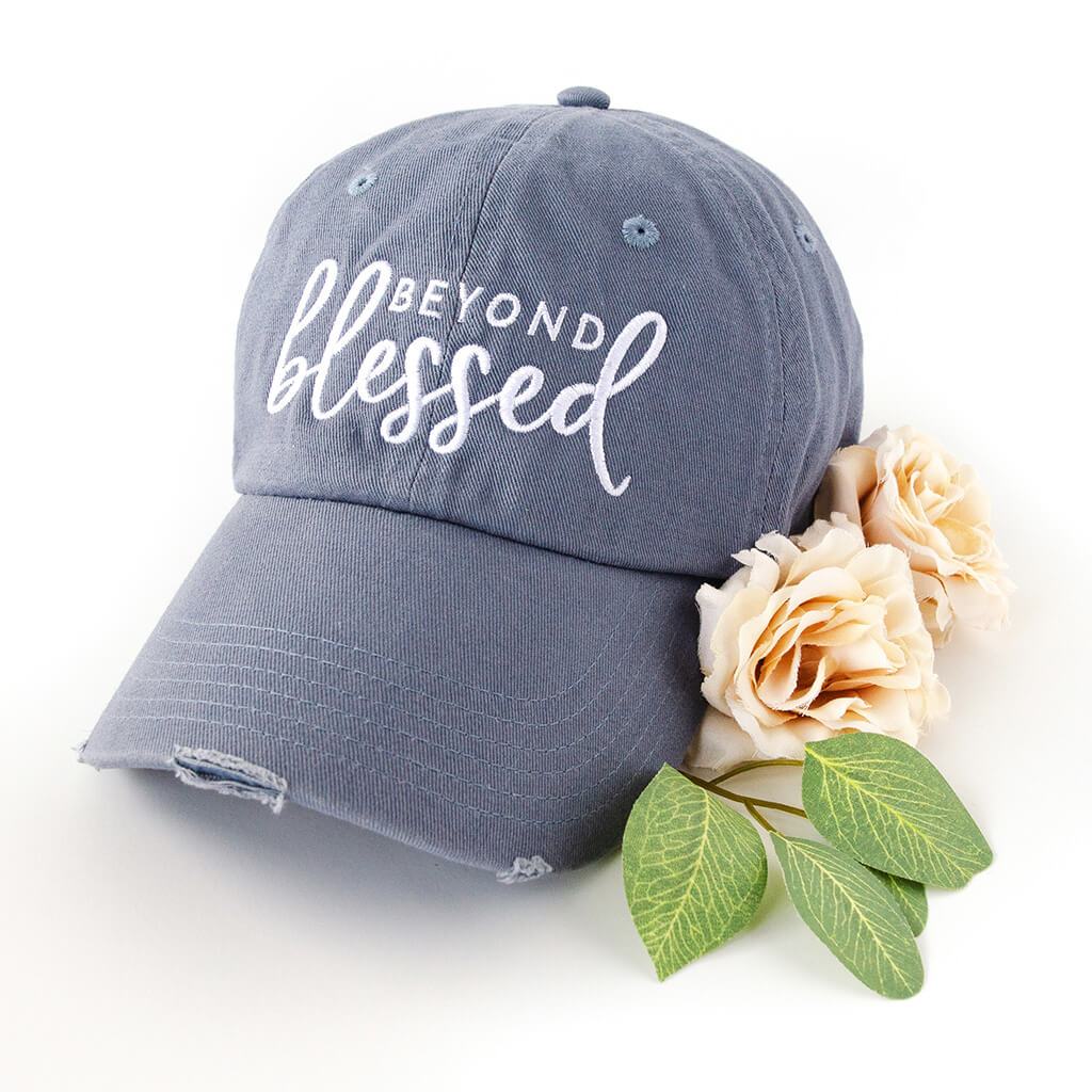 light blue distressed hat with white embroidery that reads beyond blessed