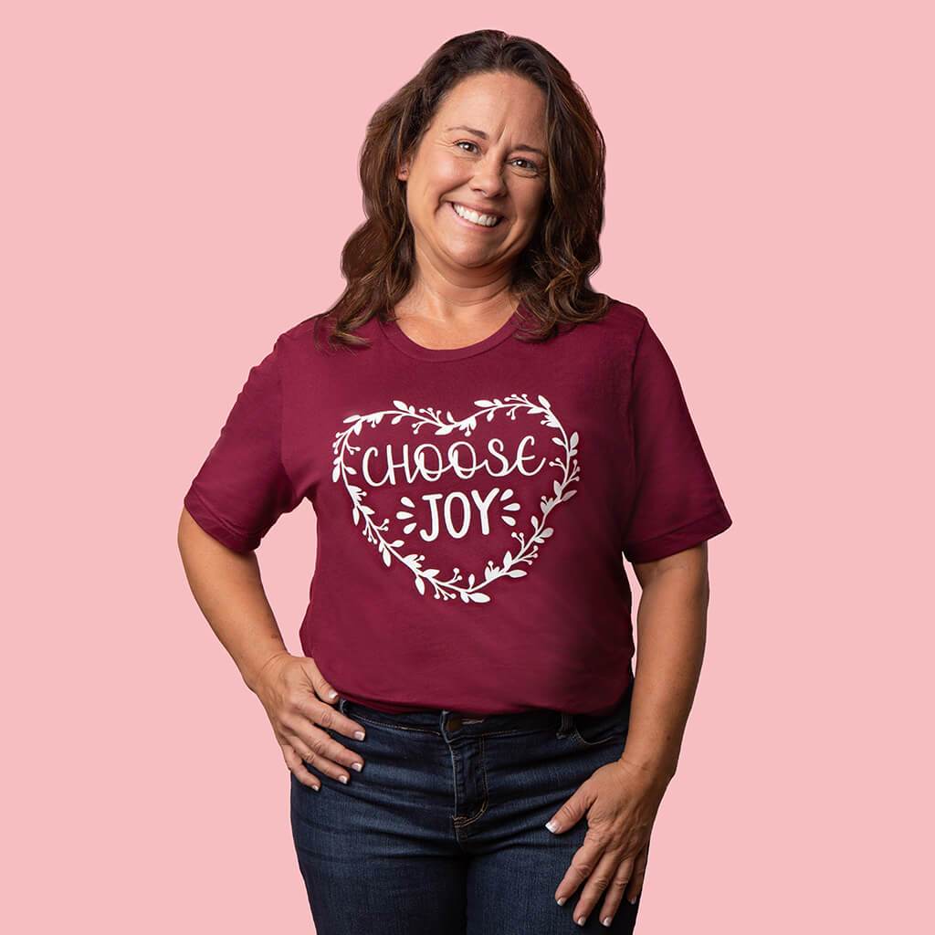 Maroon tee shirt with heart made of flowers and a "choose joy" inscription