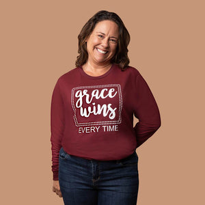 Happy Christian woman in long sleeve grace wins every time shirt