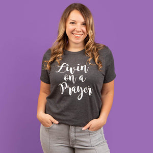 Size medium model wearing a gray Christian t-shirt for women