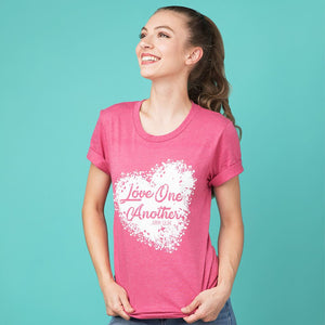 Extra small model wearing a pink love one another t-shirt